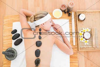 Beautiful blonde enjoying a hot stone massage