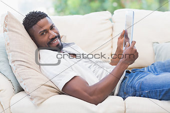 Man using his tablet on couch