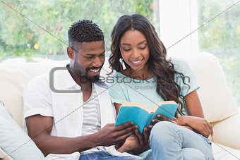 Happy couple reading on the couch