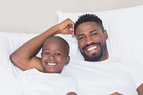 Father and son smiling at camera