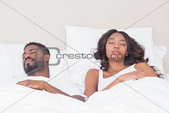 Happy couple sleeping in bed together
