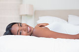 Relaxed woman lying on bed