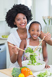 Mother and daughter making a salad together
