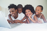 Happy family using the laptop together