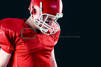 American football player taking his helmet on her head