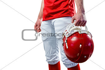 An american football player taking his helmet on her hand