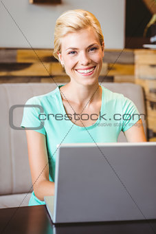 Happy pretty blonde using computer