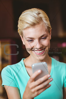 Pretty blonde woman using her smartphone