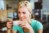 Pretty blonde holding cup of coffee