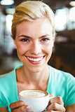 Pretty blonde holding cup of coffee
