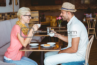 Cute couple on a date talking over a cup of coffee