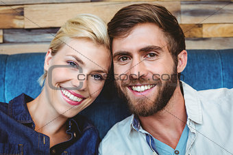 Cute couple on a date smiling at the camera