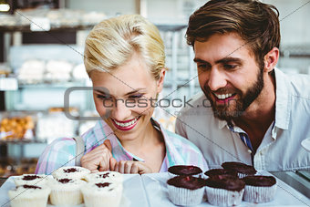 Cute couple on a date looking at cakes