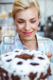 Pretty woman looking at a chocolate cake