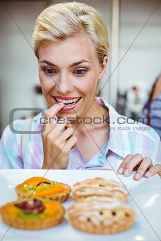 Pretty woman looking at a fruit pie