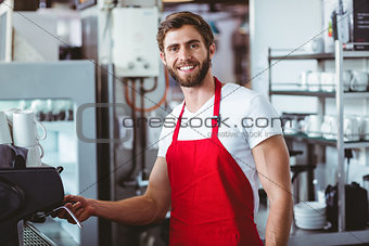 Handsome barista smiling at the camera