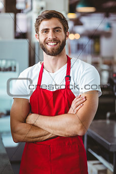 Handsome barista smiling at the camera
