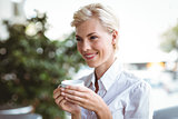 Pretty blonde having cup of coffee