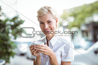Pretty blonde having cup of coffee