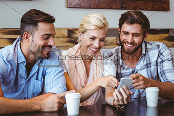 Business team looking at smartphone