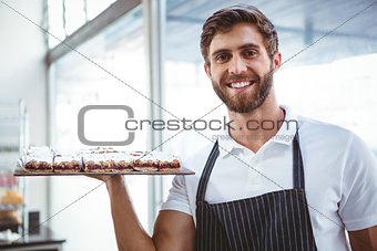 happy server holding pastry