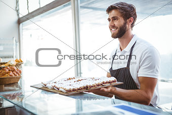 happy server holding pastry