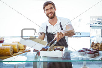 Smiling worker prepares orders