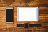 Tablet next to smartphone and swatch