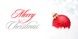 Christmas Decoration with Red Ball in the Snow on the Blurred Background with Holiday Lights. Greeting Card