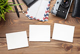 Blank photo frames, camera and supplies on table