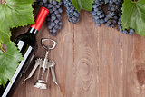 Red grape, wine bottle and corkscrew