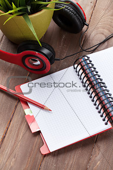 Desk with notepad and headphones