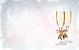 Two champagne glasses over christmas background