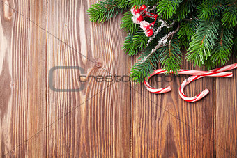 Candy cane and christmas tree on wooden table