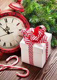 Christmas alarm clock, gift box and fir tree branch