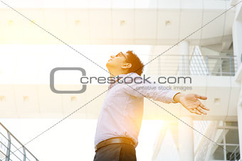 Asian Indian businessman arms outstretched 