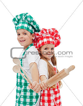 Happy chefs with wooden utensils