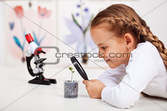 Young student studies small plant