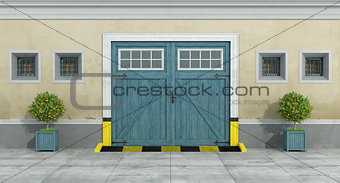 Old facade with blue car wooden garage