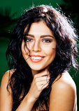 young smiling brunette woman on green background