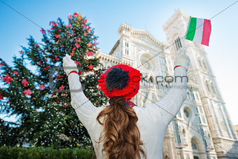 Seen from behind, woman tourist in Christmas decorated Florence