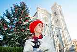 Traveler woman walking with camera in Christmas Florence