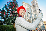 Traveler woman taking photo in Christmas decorated Florence
