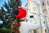 Woman taking photo of Duomo of Christmas decorated Florence
