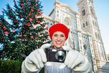 Woman tourist taking photo in Ñhristmas decorated Florence