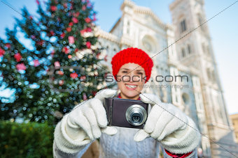 Woman taking photo in Ñhristmas decorated Florence. Close up