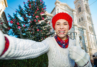 Woman tourist taking selfie in Christmas decorated Florence