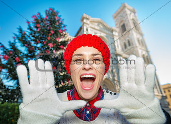 Happy woman shouting near christmas tree in Florence, Italy