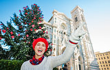 Woman pointing on something near christmas tree in Florence