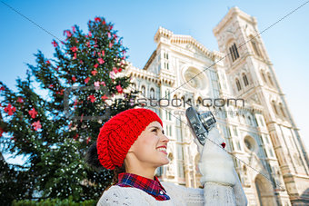 Young woman traveler making photos of Christmas in Florence